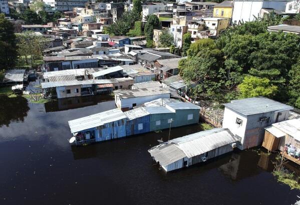 FILE - View of houses flooded by the waters of the Negro River in Manaus, Amazonas state, Brazil, June 1, 2021. The Negro River has reached its lowest level on Monday, Oct. 16, 2023, since official measurements began. The record confirms the worst drought in this part of the world's largest rainforest, just a little over two years after its most significant flooding. (AP Photo/Edmar Barros, File)