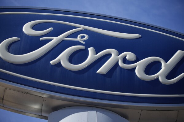 FILE - The Ford company logo is seen, Oct. 24, 2021, on a sign at a Ford dealership in southeast Denver. Ford is keeping it in the family. The 120-old automaker announced Tuesday, Sept. 12, 2023, that the great-great-granddaughter and great-great-grandson of founder Henry Ford would be taking on leadership roles in the company. (AP Photo/David Zalubowski, File)