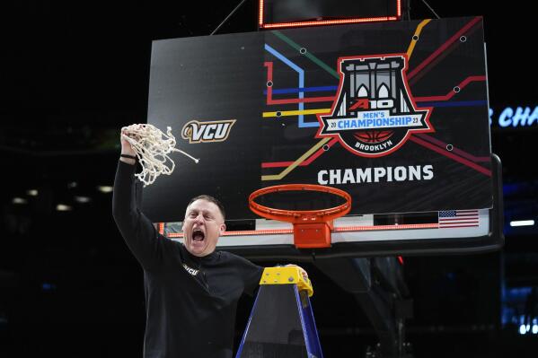 Virginia Commonwealth head coach Mike Rhoades celebrates after cutting down the net after an NCAA college basketball game against Dayton in the championship of the Atlantic 10 Conference Tournament, Sunday, March 12, 2023, in New York. Virginia Commonwealth won 68-56. (AP Photo/Frank Franklin II)