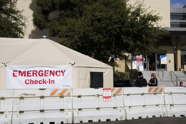 FILE - In this Dec. 17, 2020, file photo, medical tents are set up outside the emergency room at UCI Medical Center in Irvine, Calif. Doctors said on Friday, Dec. 18, increasingly desperate California hospitals are being "crushed" by soaring coronavirus infections. (AP Photo/Ashley Landis, File)