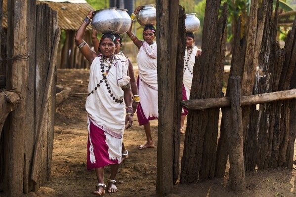Women from the Durua tribe carry water vessels in Hatipakna village, Koraput district, in India's eastern state of Odisha, Thursday, April 17, 2025. (AP Photo/Rafiq Maqbool)