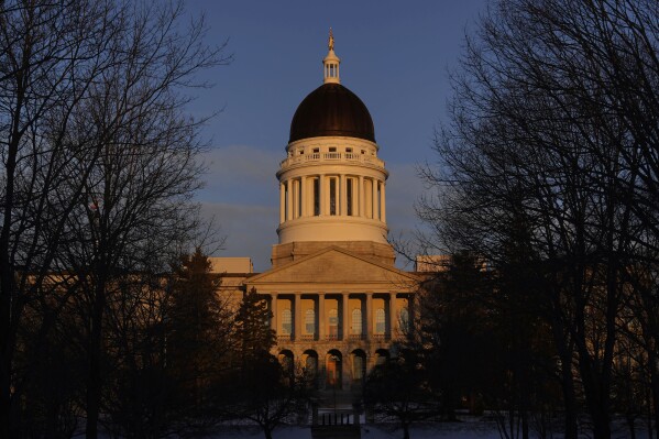 FILE - The Maine State House is seen at sunrise, March 16, 2023, in Augusta, Maine. Maine would become the 27th state to ban paramilitary training, under a bill the House narrowly passed Wednesday, Feb. 21, 2024. (AP Photo/Robert F. Bukaty, File)