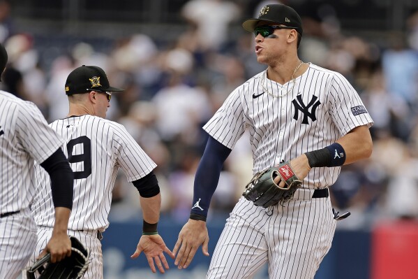 New York Yankees' Aaron Judge, right, celebrates with Jon Berti after the Yankees defeated the Chicago White Sox in a baseball game, Sunday, May 19, 2024, in New York. (AP Photo/Adam Hunger)