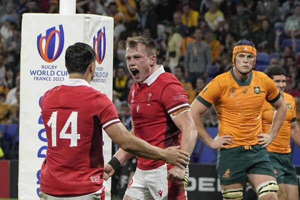 Wales' Nick Tompkins celebrates after scoring a try against Australia during a Rugby World Cup Pool C match at the Parc OL stadium in Lyon, France, Sunday, Sept. 24, 2023. (AP Photo/Laurent Cipriani)
