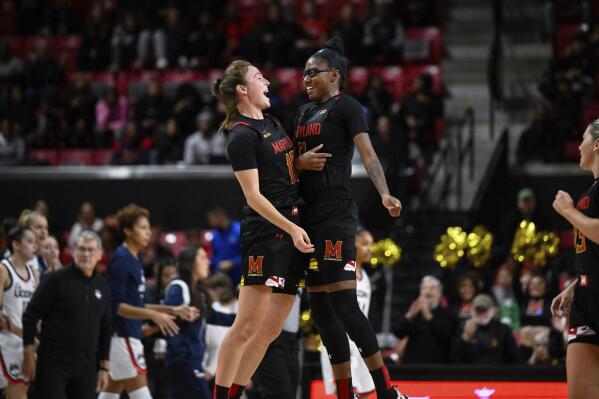 Maryland guard Abby Meyers, left, celebrates her three point basket with guard Shyanne Sellers during the first half of an NCAA college basketball game against Connecticut, Sunday, Dec. 11, 2022, in College Park, Md. (AP Photo/Terrance Williams)