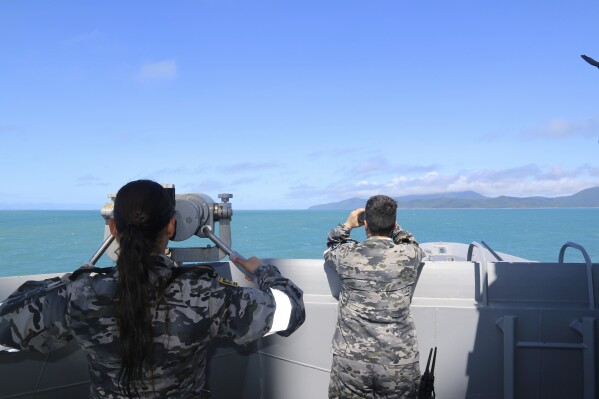 In this photo provided by Australian Defense Force, Royal Australian Navy sailors from HMAS Brisbane scan the horizon during search and rescue operations in the vicinity of Lindeman Island, Australia, on July 29, 2023. A search for an Australian army helicopter that crashed at sea with the loss of four lives last week during a military exercise with the United States had found human remains but not the black box crucial to explaining the tragedy, an officer said on Thursday, Aug. 3, 2023. (LSEW Hannah Linsley/ADF via AP)