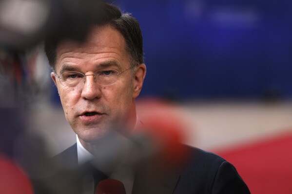 FILE - Netherland's Prime Minister Mark Rutte speaks with the media as he arrives for a EU Summit in Brussels, Thursday, March 21, 2024. Dutch Prime Minister Mark Rutte is meeting with Chinese leaders Wednesday, March 27, 2024 for talks that are expected to include the wars in Ukraine and Gaza and Dutch restrictions on the export of semiconductor manufacturing equipment to China. (AP Photo/Omar Havana, File)