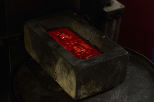 Molten gold settles in a mold at A&M Precious Metals in the St. Vincent Jewelry Center in the Jewelry District of Los Angeles, Friday, May 2, 2025. (AP Photo/Jae C. Hong)