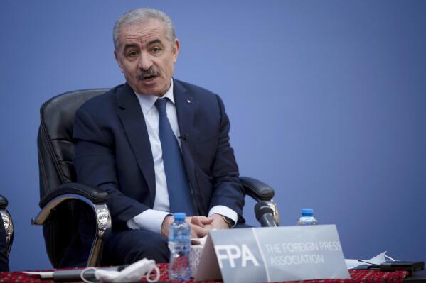 Palestinian Prime Minister Mohammad Shtayyeh, right, holds a briefing with members of the Foreign Press Association (FPA), in the West Bank city of Ramallah, Wednesday, Nov. 10, 2021. (AP Photo/Majdi Mohammed)