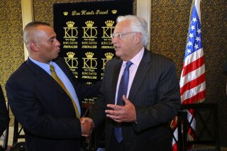 
              In this May 1, 2018 photo, Palestinian businessman Ashraf Jabari, left, shakes hands with U.S. Ambassador to Israel David Friedman at the King David Hotel in Jerusalem. Jabari, who flouts political taboos by working with Israeli settlers in the West Bank, could soon be playing a key role in President Donald Trump’s Middle East peace plan, but he is reviled by fellow Palestinians who view him with suspicion. While Palestinian officials have rejected next month’s planned conference in Bahrain, Jabari says he will be thrilled to attend. (AP Photo/Matanya Ofir)
            