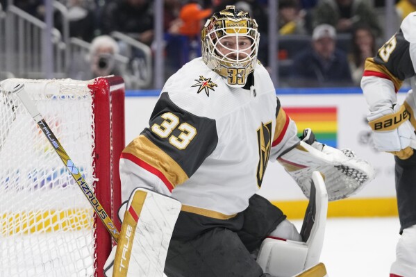 Vegas Golden Knights goaltender Adin Hill protects the net during the second period of the team's NHL hockey game against the New York Islanders on Tuesday, Jan. 23, 2024, in Elmont, N.Y. (AP Photo/Frank Franklin II)
