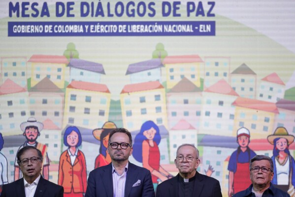 FILE - Colombia's President Gustavo Petro, from left, Carlos Ruiz Massieu, Special Representative of the Secretary-General, Monsignor Hector Henao and National Liberation Army leader Israel Ramirez, alias Pablo Beltran, attend a ceremony to formally begin a six-month cease-fire as part of a process to forge a permanent peace between the National Liberation Army or ELN, and the government, in Bogota, Colombia, Thursday, Aug. 3, 2023. Colombian President Gustavo Petro’s commitment to transform long-marginalized rural and conflict areas and new peace efforts were the highlights of his first year in office, the U.N. special envoy for the South American country said.(AP Photo/Ivan Valencia, File)