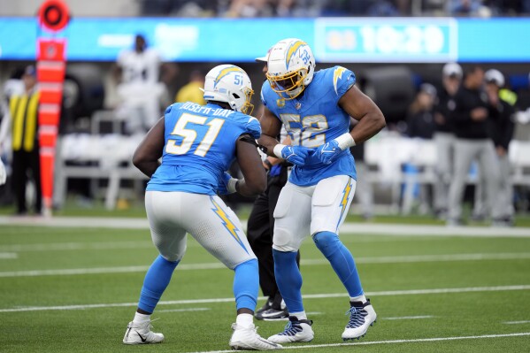 Los Angeles Chargers linebacker Khalil Mack (52) celebrates his tackle with defensive tackle Sebastian Joseph-Day (51) during the second half of an NFL football game against the Las Vegas Raiders Sunday, Oct. 1, 2023, in Inglewood, Calif. (AP Photo/Ashley Landis)