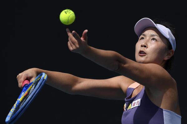 FILE - China's Peng Shuai serves to Japan's Nao Hibino during their first round singles match at the Australian Open tennis championship in Melbourne, Australia, on Jan. 21, 2020. The whereabout of Peng remains a pressing question at the Beijing Olympics. Peng’s accusations of sexual assault months ago against former vice premier Zhang Gaoli, once a member of the all-powerful Politburo Standing Committee, were scrubbed almost immediately from the internet in China. (AP Photo/Andy Brownbill, File)