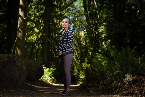 Amelia Marchand, citizen of the Confederated Tribes of the Colville Reservation, poses for a portrait at NatureBridge in the Olympic National Park during the 2023 Tribal Climate Camp, Thursday, Aug. 17, 2023, near Port Angeles, Wash. (AP Photo/Lindsey Wasson)