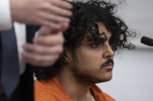 Raad Almansoori listens during a court hearing on Feb. 26, 2024, in Maricopa County Superior Court in Phoenix. On Tuesday, March 5, 2024, Almansoori pleaded not guilty to attempted murder and other felony charges stemming from separate stabbings of two women in metro Phoenix during February 2024. Almansoori is also being sought in New York in the fatal bludgeoning of a woman in a Manhattan hotel. (Mark Henle, The Arizona Republic via AP)