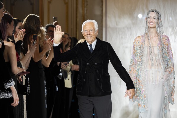 Giorgio Armani gestures at the end of the Giorgio Armani Prive Haute Couture Spring Summer 2025 collection in Paris, on Jan. 28, 2025. (AP Photo/Lewis Joly, File).