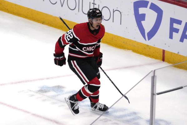 Chicago Blackhawks center Kirby Dach, right, celebrates his tying