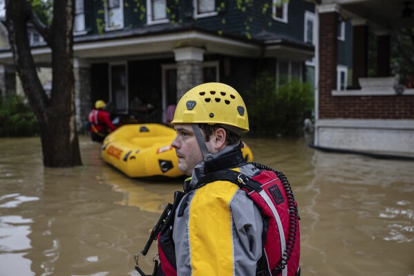 Search and rescue firefighters conduct wellness checks in a neighborhood on Sunday, April 6, 2025, in Frankfort, Ky. (AP Photo/Jon Cherry)