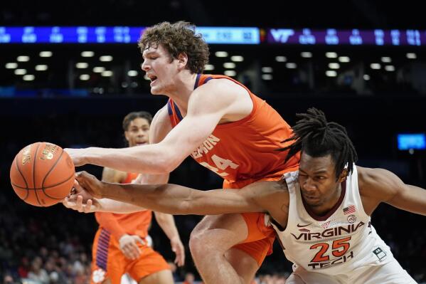 Virginia Tech's Justyn Mutts (25) and Clemson's PJ Hall (24) battle for a loose ball in the second half of an NCAA college basketball game during the Atlantic Coast Conference men's tournament, Wednesday, March 9, 2022, in New York. (AP Photo/John Minchillo)