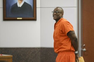 FILE - In this Tuesday, Nov. 26, 2019 file photo, Lydell Grant smiles in court after he was ordered to be released on bond in Houston. On Friday, Dec. 20, 2019, the Harris County District Attorney's Office said that Grant has been cleared in the death of 28-year-old Aaron Scheerhoorn. New evidence has pointed to 41-year-old Jermarico Carter as the killer. Carter was arrested Thursday in Georgia. ( Jon Shapley/Houston Chronicle via AP)