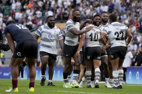 Fiji's players celebrate at the rugby union international match between England and Fiji at Twickenham stadium in London, Saturday, Aug. 26, 2023. Fiji beat England by 22-30. (AP Photo/Alastair Grant)
