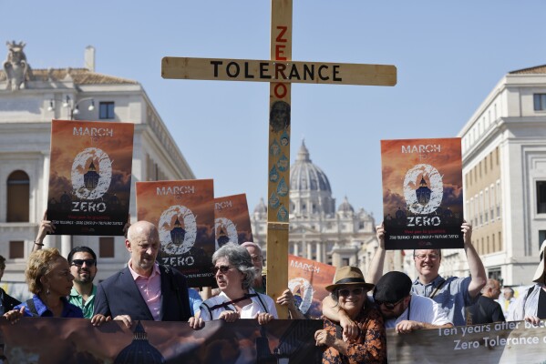 From left, survivor-activists psychoneurologist Denise Buchanan, psychotherapist Peter Isely, Kazlaw Injury & Trauma Lawyers' support team specialist Leona Huggins and president of Ending Clergy Abuse Timothy Law hold a wooden cross as they arrive at the Vatican, Sept. 27, 2023, at the end of their pilgrimage to protest the pope's failure to end clergy abuse. (AP Photo/Riccardo De Luca, File)