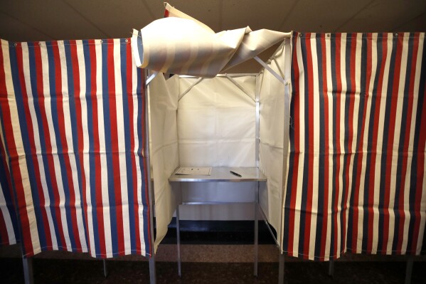 FILE - A booth is ready for a voter, Feb. 24, 2020, at City Hall in Cambridge, Mass., on the first morning of early voting in the state. The U.S. is warning other democracies that Russia appears to be opening up a new front in its covert campaign against democracy — sowing doubts about the reliability of elections in general. Encouraged by its success amplifying doubts about election procedures like mail balloting used in the 2020 U.S. presidential election, Russian intelligence is trying to do the same in several other countries, according to U.S. intelligence. (AP Photo/Elise Amendola, File)