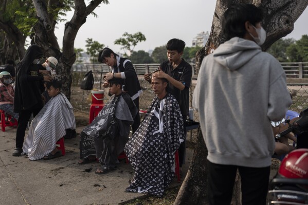 Residents get free haircuts from trainee stylists in Ho Chi Minh City, Vietnam, Jan. 14, 2024. (AP Photo/Jae C. Hong)