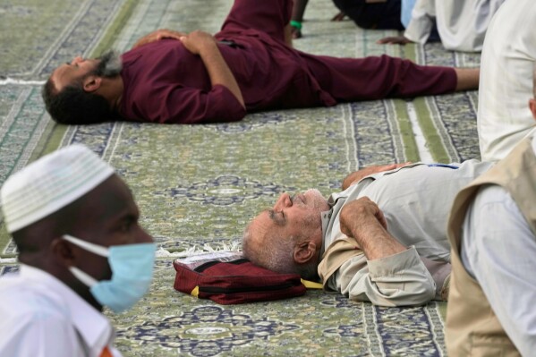 Muslim pilgrims take a nap at the Grand Mosque during the annual Hajj pilgrimage, in Mecca, Saudi Arabia, Tuesday, June 3, 2025. (AP Photo/Amr Nabil)