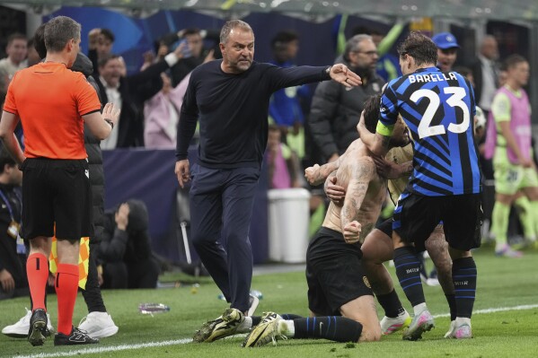 Inter Milan players celebrate in front ot Barcelona's head coach Hansi Flick during the Champions League semifinal second leg soccer match between Inter Milan and Barcelona at San Siro stadium in Milan , Italy, Tuesday, May 6, 2025. (AP Photo/Antonio Calanni)