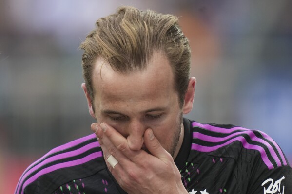 Bayern's Harry Kane reacts after he was injured during a German Bundesliga soccer match between SV Darmstadt 98 and Bayern Munich in Darmstadt, Germany, Saturday, March 16, 2024. (AP Photo/Michael Probst)