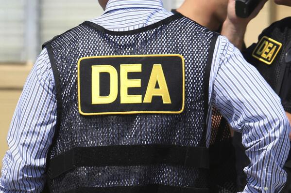 FILE - This June 13, 2016, file photo shows Drug Enforcement Administration agents in Florida.  A current U.S. Drug Enforcement Administration agent and a former supervisor in the agency were indicted Friday, May 20, 2022 on federal charges accusing them of leaking confidential law enforcement information to defense lawyers in Florida in exchange for cash and gifts. (Joe Burbank/Orlando Sentinel via AP)