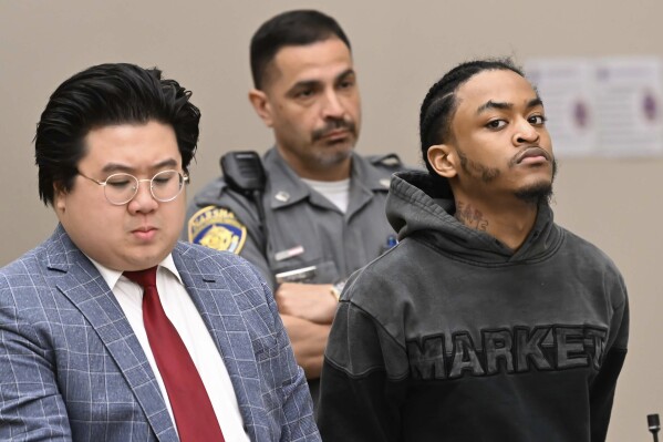 Suspect Tajuan Washington, with public defender Justin Chan, during his arraignment Wednesday May 28, 2025, in Waterbury Superior Court and has been charged with assault and weapons crimes in a shooting at the Brass Mill Center on Tuesday afternoon, May 27, in Waterbury, Conn. (Jim Shannon/Hearst Connecticut Media via AP)
