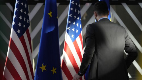 FILE - A worker adjusts the US and EU flags prior to the arrival of European Union foreign policy chief Josep Borrell and United States Secretary of State Antony Blinken during the EU-US Energy Council Ministerial meeting at the European Council building in Brussels, on April 4, 2023. The European Union signed off Monday July 10, 2023 on a new agreement over the privacy of people's personal information that gets pinged across the Atlantic, aiming to ease European concerns about electronic spying by American intelligence agencies. (AP Photo/Virginia Mayo, File)