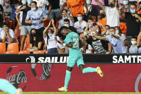 Real Madrid's Vinicius Junior celebrates after scoring his side's first goal during a Spanish La Liga soccer match between Valencia and Real Madrid at the Mestalla stadium in Valencia, Spain, Sunday, Sept. 19, 2021. (AP Photo/Alberto Saiz)