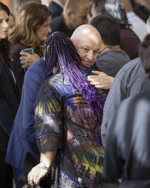 New Zealand's Prime Minister Christopher Luxon embraces a survivor following his "formal and unreserved" apology in Parliament for the widespread abuse, torture and neglect of hundreds of thousands of children and vulnerable adults in care, in Wellington, New Zealand, Tuesday, Nov. 12, 2024. (Monique Ford/Stuff via AP)