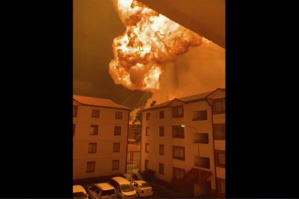 This grab taken from video provided by Philip Awinyo Jeremiah shows a fireball after a vehicle loaded with gas which exploded, in Nairobi, Kenya, Friday, Feb. 2, 2024. The truck explosion ignited a huge fireball, and a flying gas cylinder set off a fire that burned down the Oriental Godown, a warehouse that deals with garments and textiles, according to government spokesman Isaac Mwaura. ( (Philip Awinyo Jeremiah via AP)