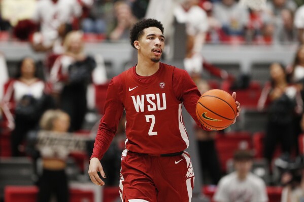 Washington State guard Myles Rice controls the ball during the second half of an NCAA college basketball game against Washington, Thursday, March 7, 2024, in Pullman, Wash. (AP Photo/Young Kwak)