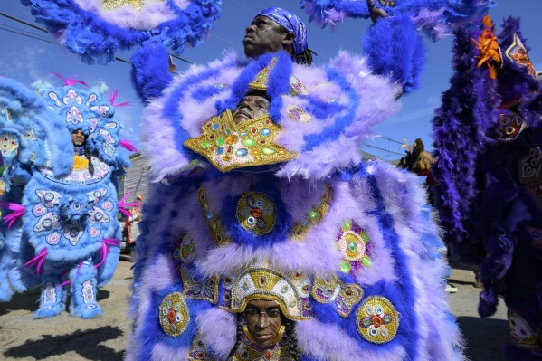 Members of the Monogram Hunters Black Masking Indians parade on Mardi Gras Day in New Orleans, Tuesday, Feb. 13, 2024. (AP Photo/Matthew Hinton)