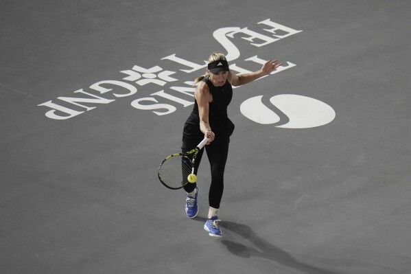 Caroline Wozniacki, of Denmark, returns the ball during an exhibition tennis match against Maria Sakkari of Greece, at the Plaza de Toros bullring in Mexico City, Wednesday, Nov. 29, 2023. (APPhoto/Eduardo Verdugo)