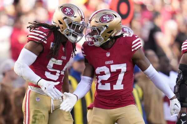San Francisco 49ers linebacker Fred Warner (54) celebrates with safety Ji'Ayir Brown (27) during the second half of an NFL football game against the Tampa Bay Buccaneers in Santa Clara, Calif., Sunday, Nov. 19, 2023. (AP Photo/Godofredo A. Vásquez)