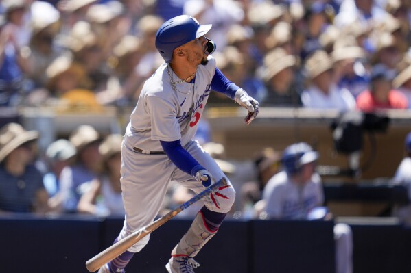 Los Angeles Dodgers' Mookie Betts watches his grand slam during the fourth inning of a baseball game against the San Diego Padres, Monday, Aug. 7, 2023, in San Diego. (AP Photo/Gregory Bull)