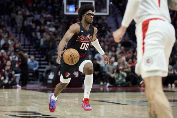 Portland Trail Blazers guard Scoot Henderson brings the ball up against the Los Angeles Clippers during the first half of an NBA basketball game in Portland, Ore., Wednesday, March 20, 2024. (AP Photo/Craig Mitchelldyer)