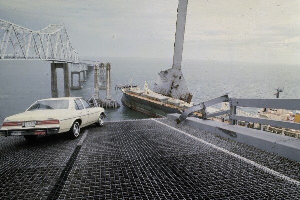 FILE - A car is halted at the edge of the Sunshine Skyway Bridge across Tampa Bay, Fla., after the freighter Summit Venture struck the bridge during a thunderstorm and tore away a large part of the span, May 9 1980. A container ship struck a major bridge in Baltimore early Tuesday, March 26, 2024, causing it to plunge into the river below. From 1960 to 2015, there have been 35 major bridge collapses worldwide due to ship or barge collision. (AP Photo/Jackie Green, File)
