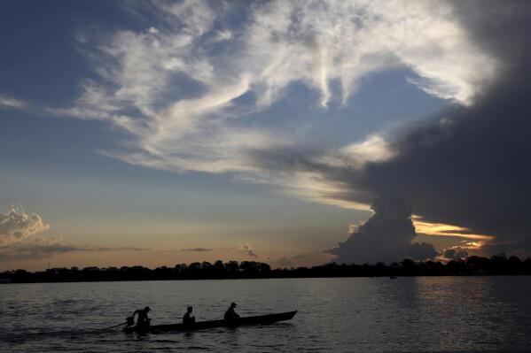 FILE - Local residents navigate the Amazon River near Leticia, Colombia, Sept. 7, 2019. Gustavo Petro, Colombia's first elected leftist president, will take office in August with ambitious proposals to halt the record-high rates of deforestation in the Amazon. (AP Photo/Fernando Vergara, File)