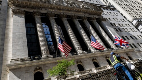 A man rides on a bicycle past the New York Stock Exchange, Tuesday, Sept. 13, 2022, in New York. (AP Photo/Julia Nikhinson)