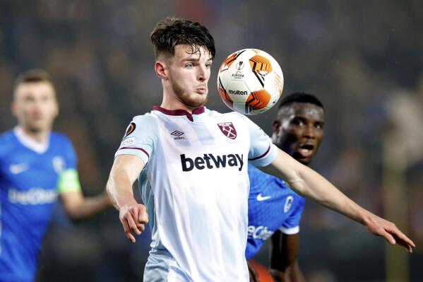 West Ham's Declan Rice, center, eyes the ball during a group H Europa League soccer match between Genk and West Ham at the KRC Genk Arena in Genk, Belgium, Thursday, Nov. 4, 2021. (AP Photo/Olivier Matthys)