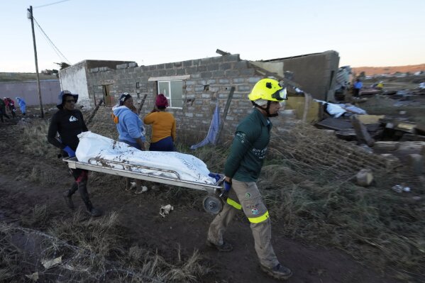 Rescue workers transport a person in a body bag after floods swept through the area in Mthatha, South Africa, Thursday, June 12, 2025. (AP Photo/Themba Hadebe, File)