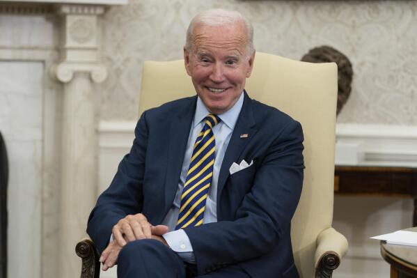 FILE - President Joe Biden smiles in the Oval Office of the White House, Sept. 16, 2022, in Washington. The White House is reaching out to local governments. It's hosting officials from North Carolina on Thursday to highlight funding opportunities and hear firsthand how coronavirus relief, infrastructure dollars and other policies are faring in communities. (AP Photo/Alex Brandon, File)
